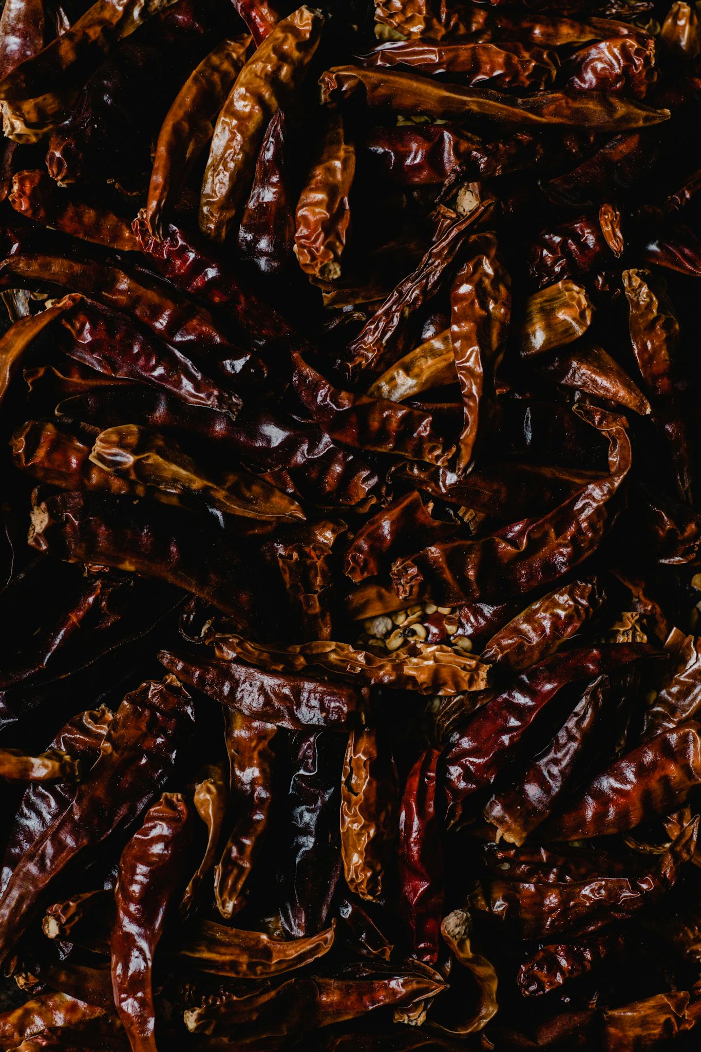 High-quality close-up image of dried chili peppers, capturing their textures and red hues.